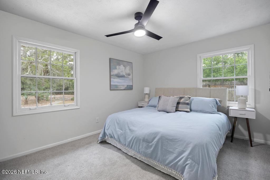 4634 Whimbrel Lane Fernandina Beach, FL 32034 - Photo 22 of 42 a bedroom with a bed and a window
