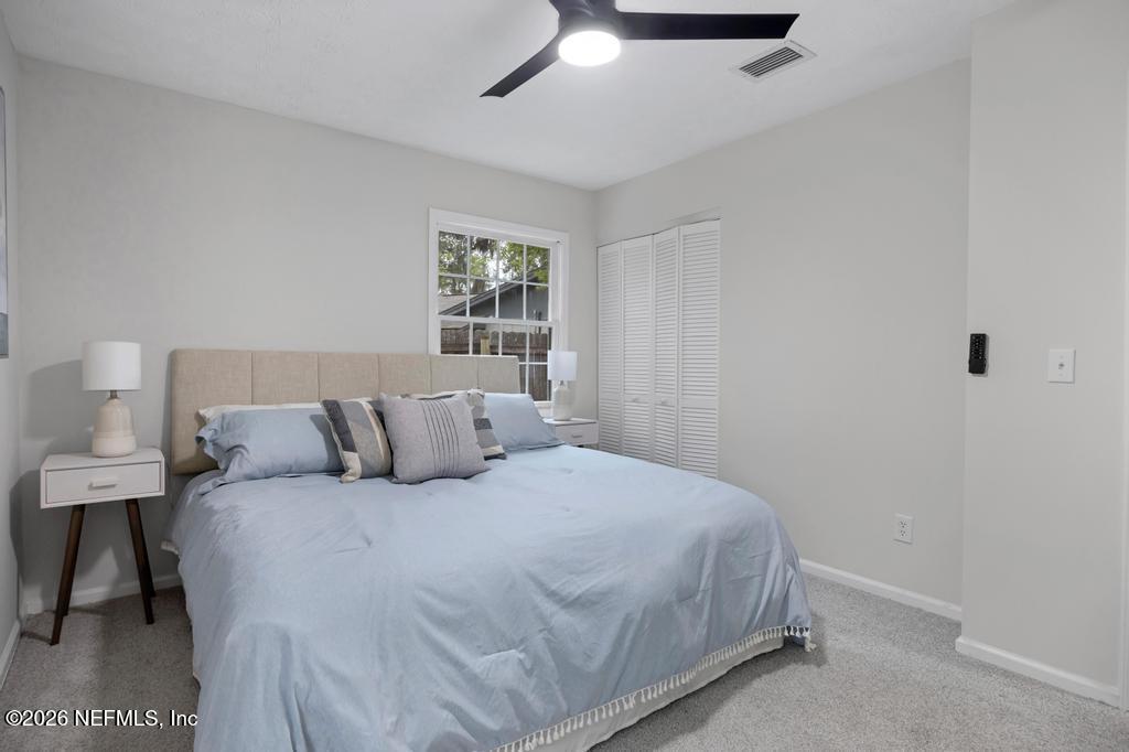4634 Whimbrel Lane Fernandina Beach, FL 32034 - Photo 23 of 42 a bedroom with a bed and a window