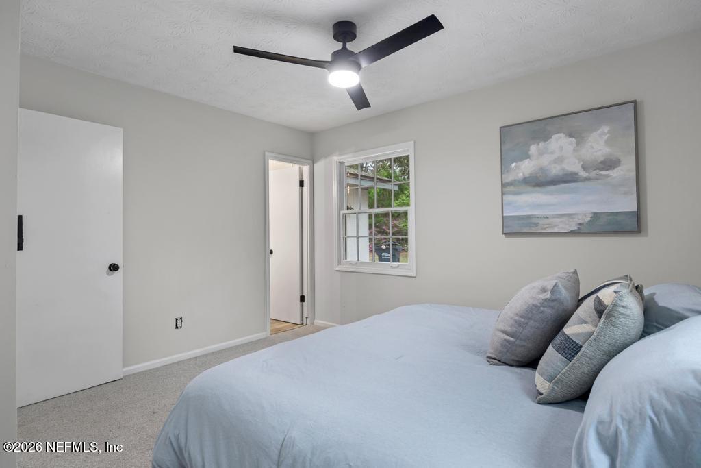 4634 Whimbrel Lane Fernandina Beach, FL 32034 - Photo 24 of 42 a bedroom with a bed and a painting on the wall