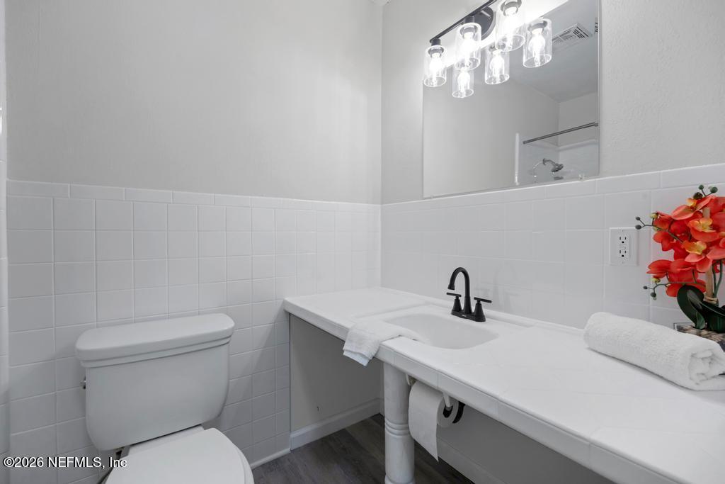 4634 Whimbrel Lane Fernandina Beach, FL 32034 - Photo 30 of 42 a bathroom with a sink vanity and toilet