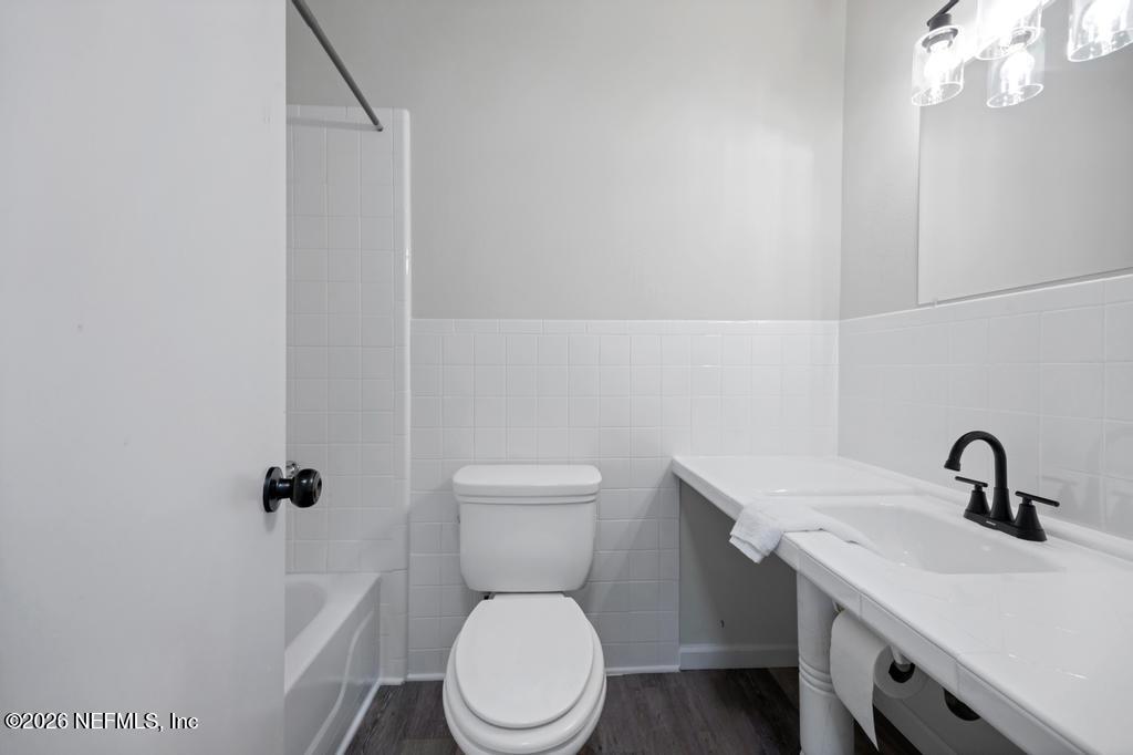 4634 Whimbrel Lane Fernandina Beach, FL 32034 - Photo 31 of 42 a bathroom with a toilet a sink and mirror