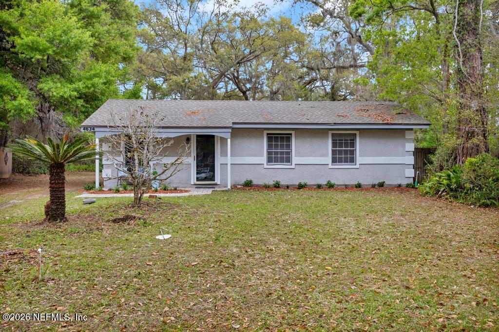 4634 Whimbrel Lane Fernandina Beach, FL 32034 - Photo 33 of 42 a front view of a house with garden