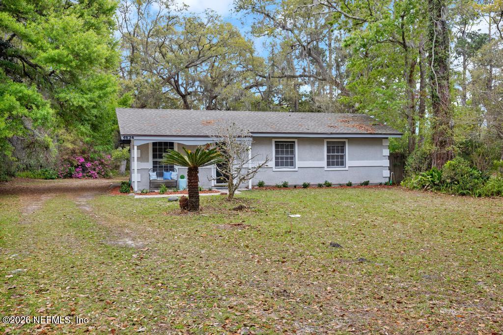4634 Whimbrel Lane Fernandina Beach, FL 32034 - Photo 34 of 42 a front view of a house with garden