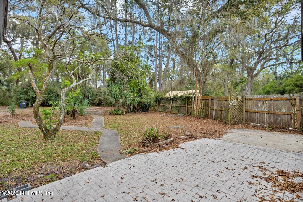 4634 Whimbrel Lane Fernandina Beach, FL 32034 - Photo 38 of 42 a backyard of a house with a trees and plants