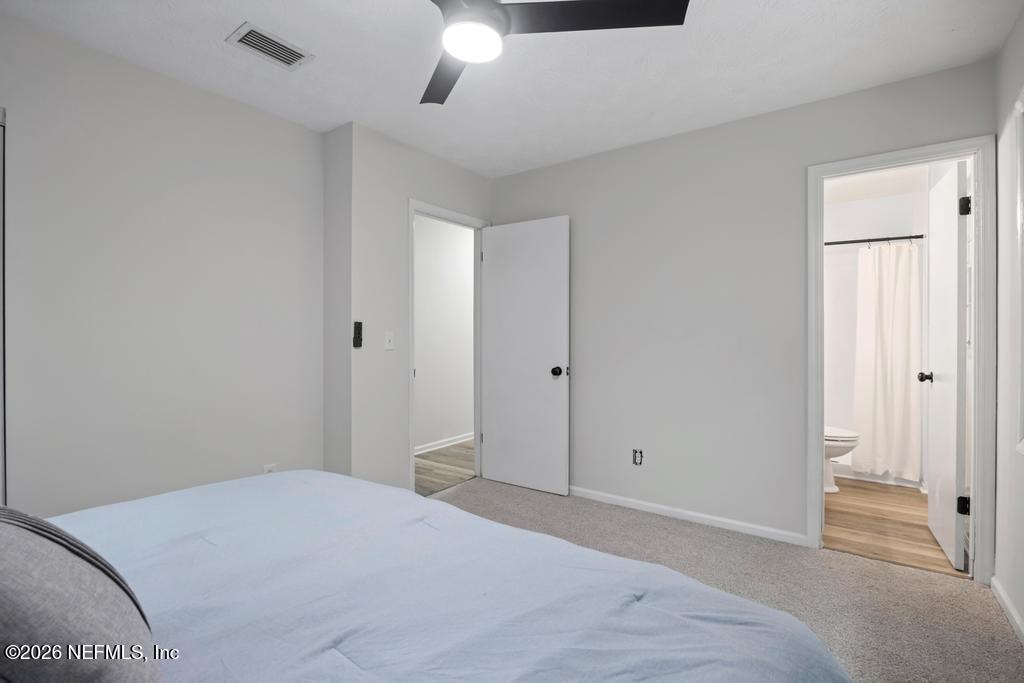 4634 Whimbrel Lane Fernandina Beach, FL 32034 - Photo 9 of 42 a bedroom with a bed and a ceiling fan