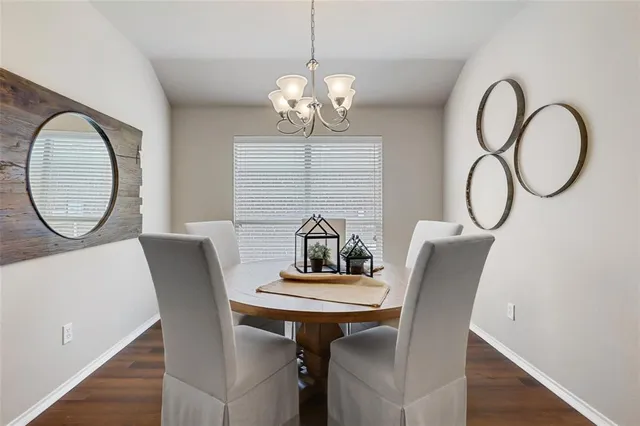 a view of a dining room with furniture and a chandelier