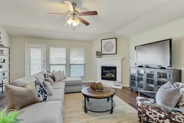 a living room with furniture a fireplace and a flat screen tv