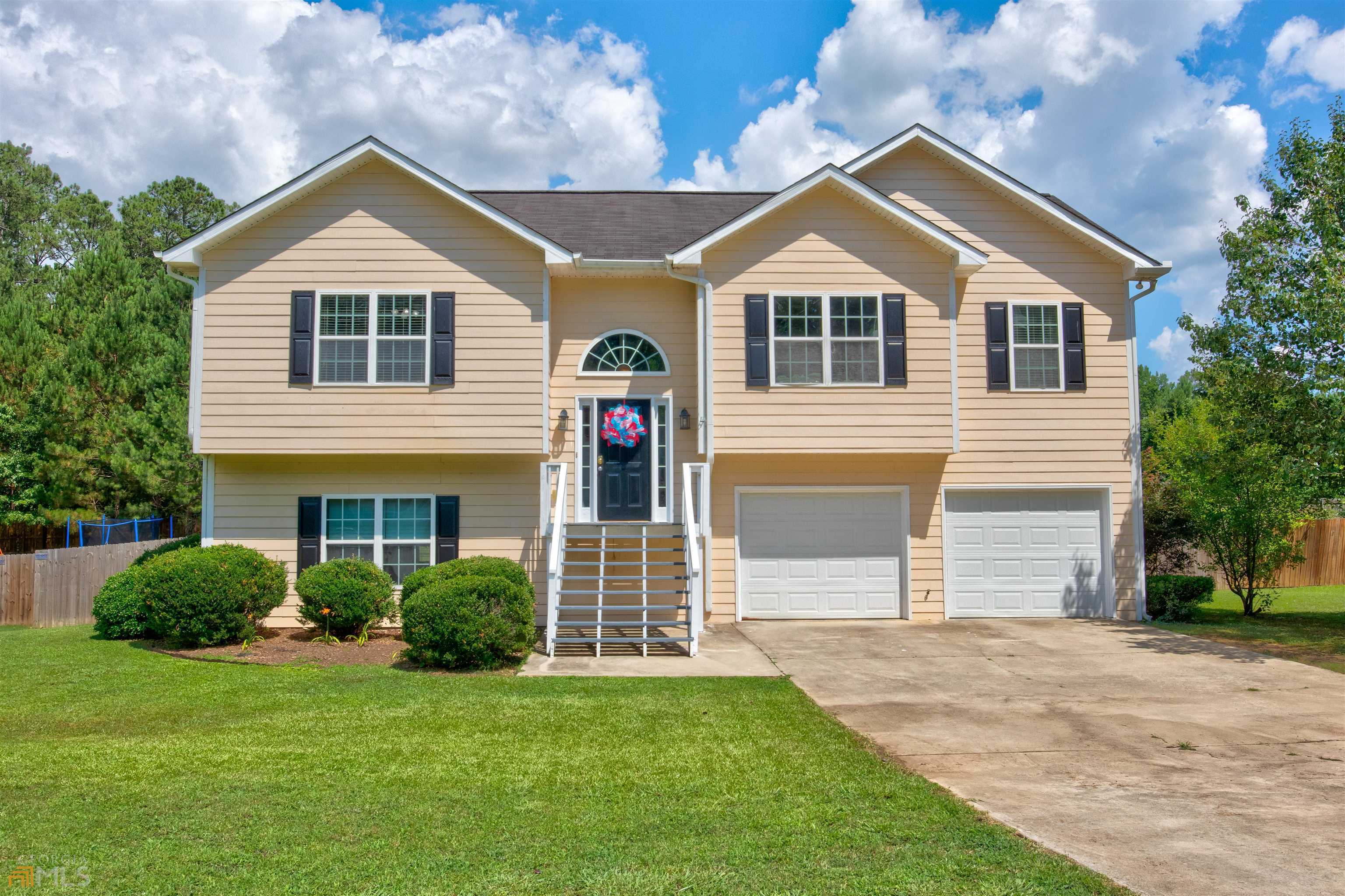 a front view of a house with a yard and garage