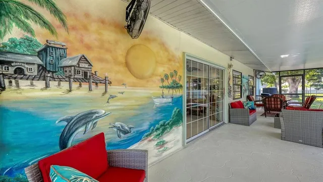 a living room with furniture and a floor to ceiling window