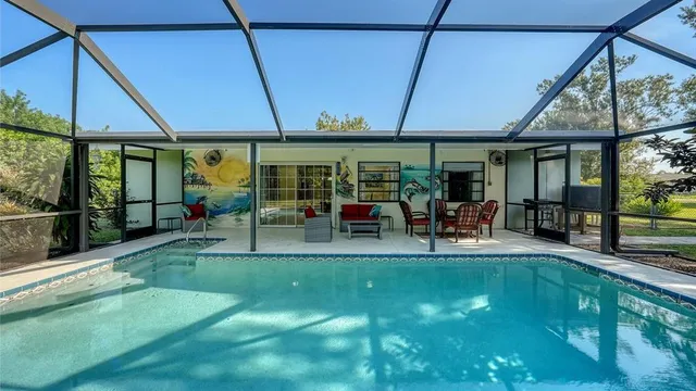 a view of a patio with table and chairs under an umbrella