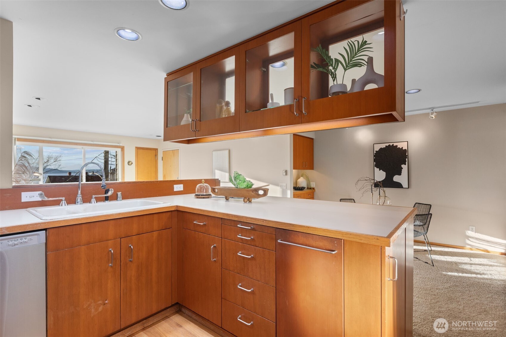 3200 Alki Avenue Southwest, Unit 301 Seattle, WA 98116 - Photo 12 of 29 a kitchen with a sink and cabinets