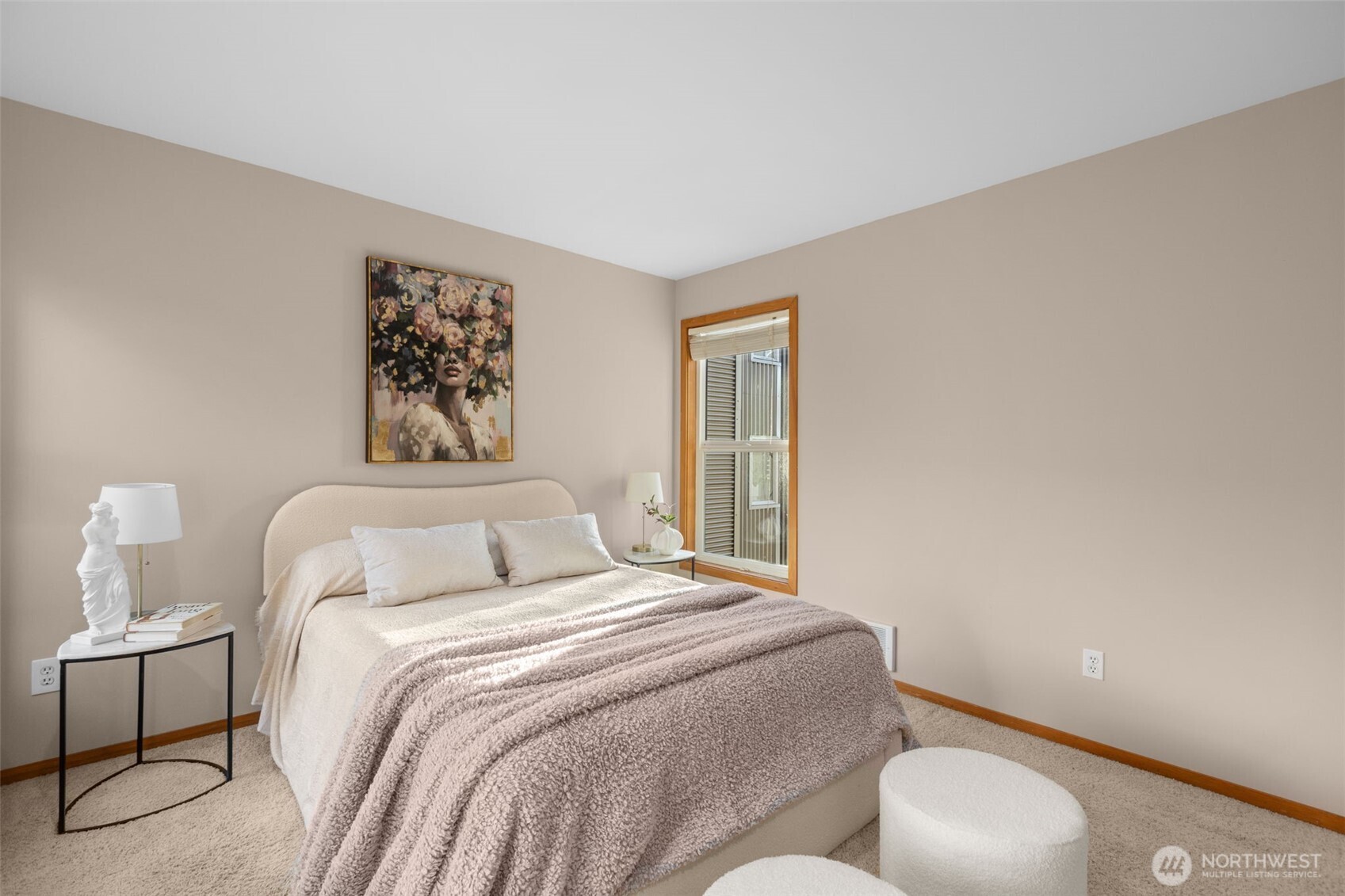 3200 Alki Avenue Southwest, Unit 301 Seattle, WA 98116 - Photo 15 of 29 a bedroom with a bed and a painting on the wall