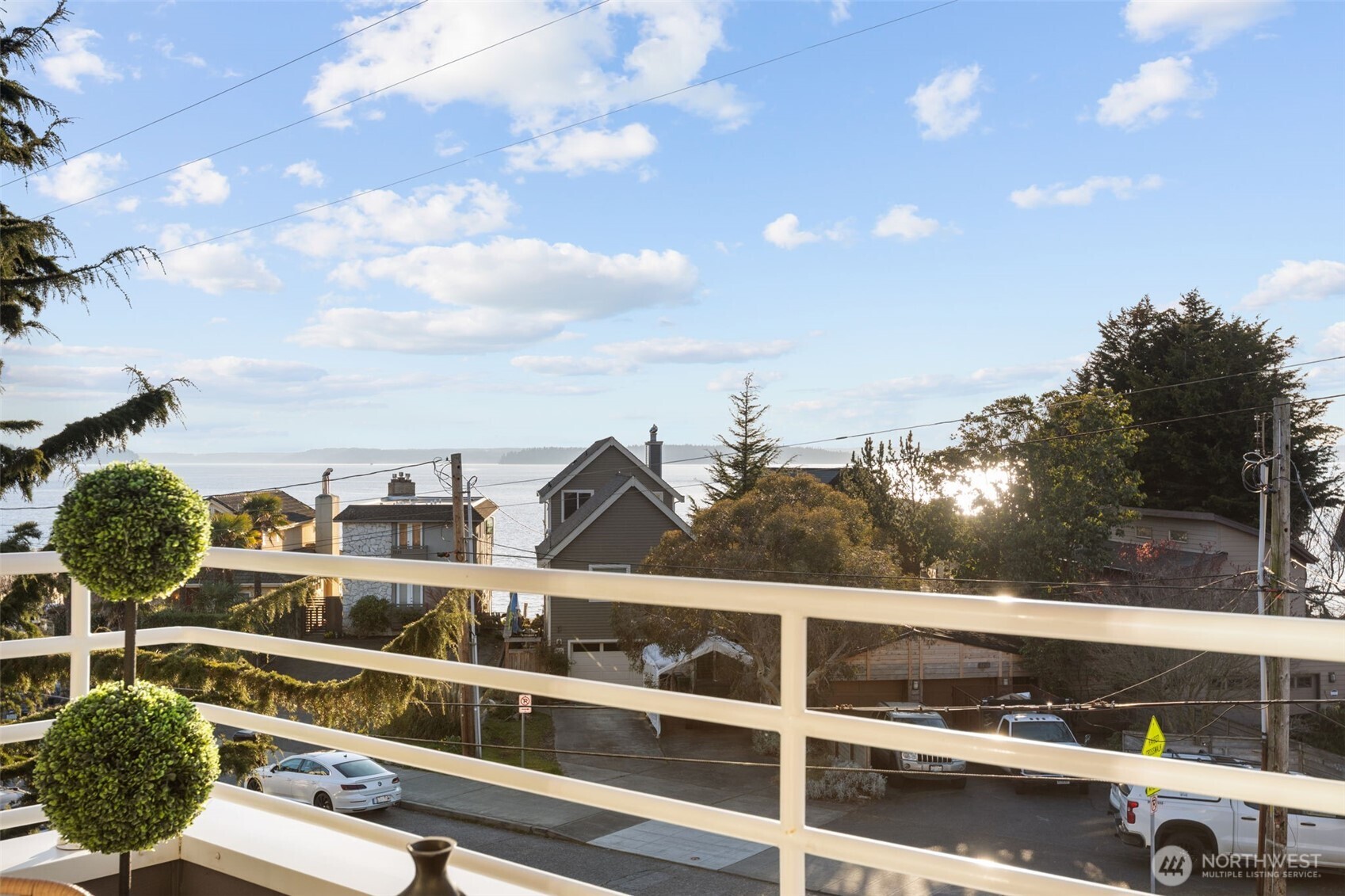 3200 Alki Avenue Southwest, Unit 301 Seattle, WA 98116 - Photo 24 of 29 a view of a balcony with many windows and plants