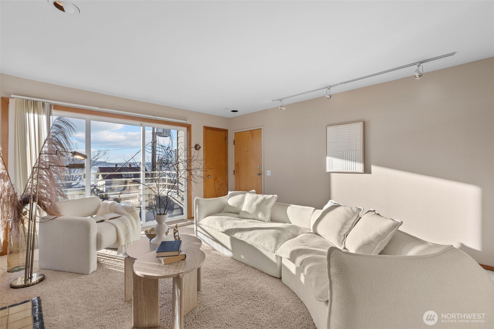 3200 Alki Avenue Southwest, Unit 301 Seattle, WA 98116 - Photo 4 of 29 a living room with furniture and a large window