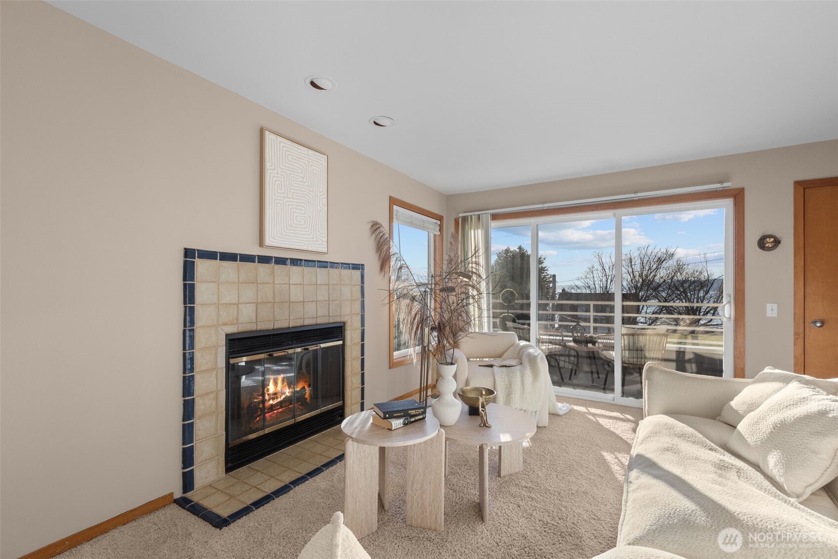 3200 Alki Avenue Southwest, Unit 301 Seattle, WA 98116 - Photo 5 of 29 a living room with furniture a large window and a fireplace