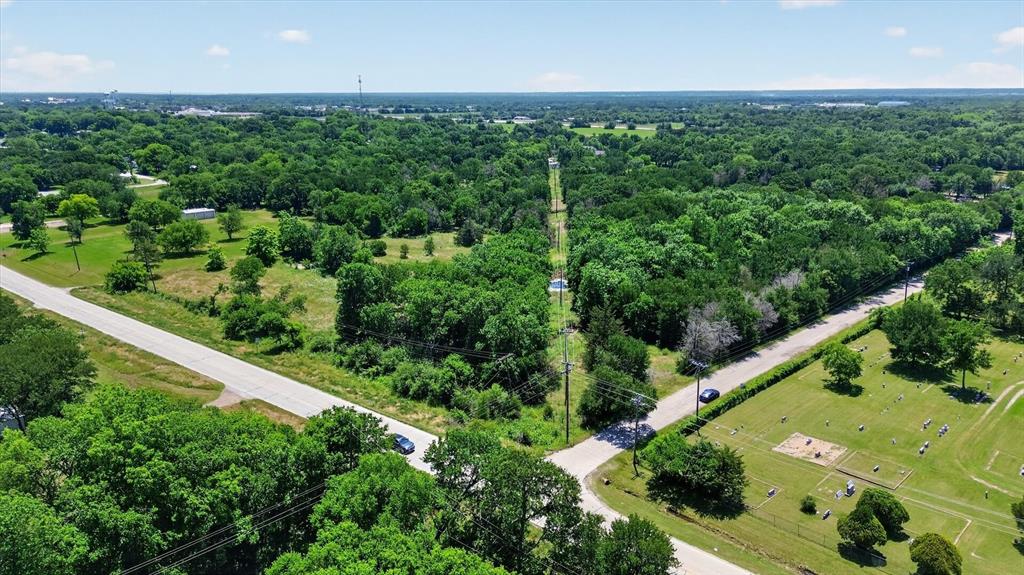 613 Main Street Quinlan, TX 75474 - Photo 1 of 16 Overhead view showcasing a verdant landscape with extensive tree coverage