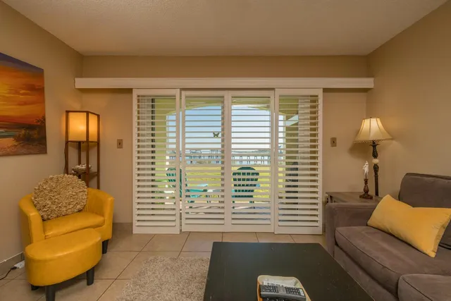 a bedroom with furniture and a large window