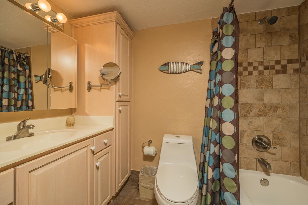 7265 A1A South, Unit B3 St. Augustine, FL 32080 - Photo 25 of 45 a bathroom with a sink vanity granite toilet and shower