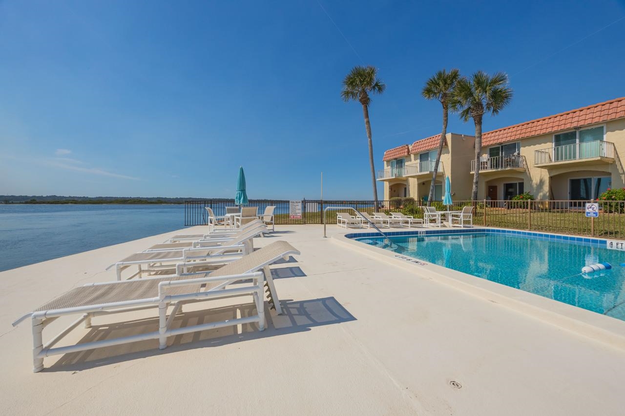 7265 A1A South, Unit B3 St. Augustine, FL 32080 - Photo 28 of 45 a view of a swimming pool with a lounge chair
