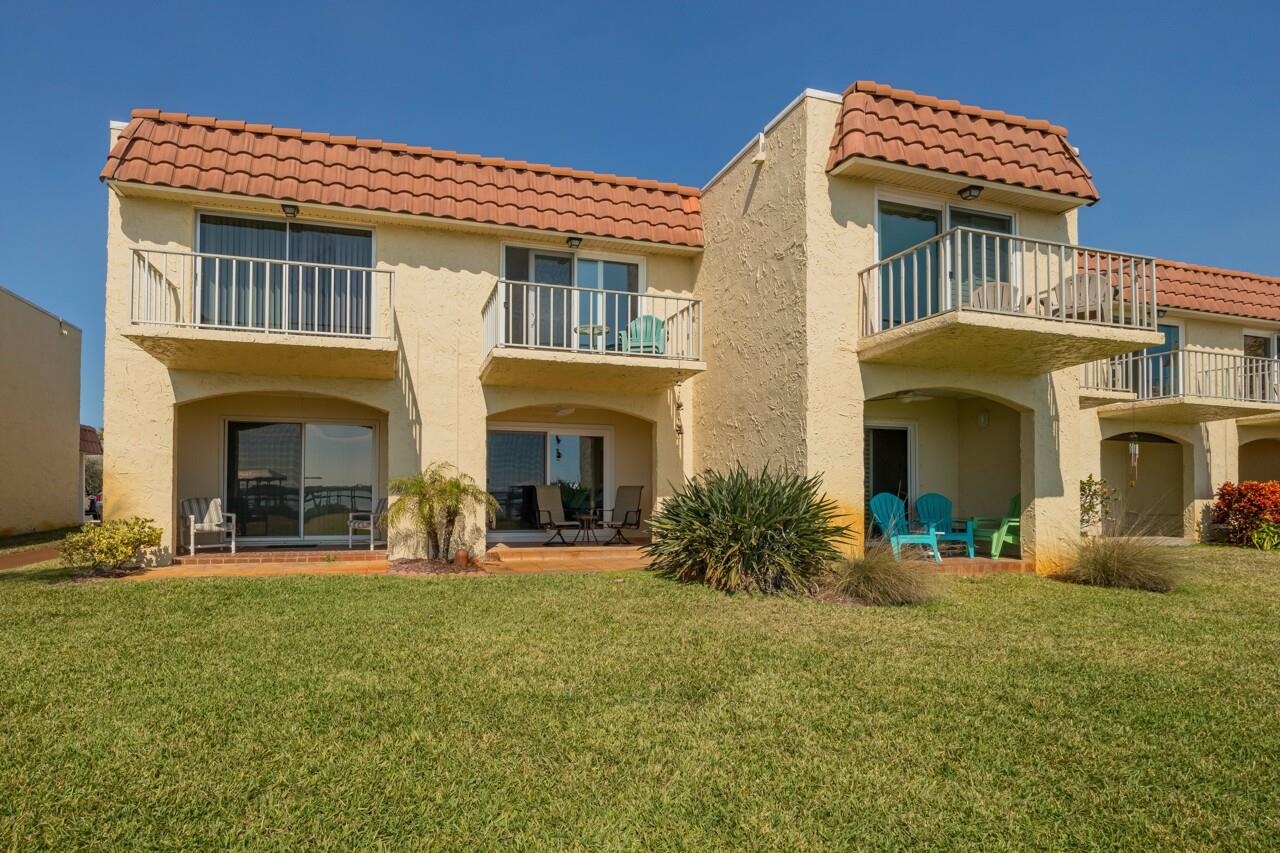 7265 A1A South, Unit B3 St. Augustine, FL 32080 - Photo 29 of 45 a front view of a house with yard and outdoor seating