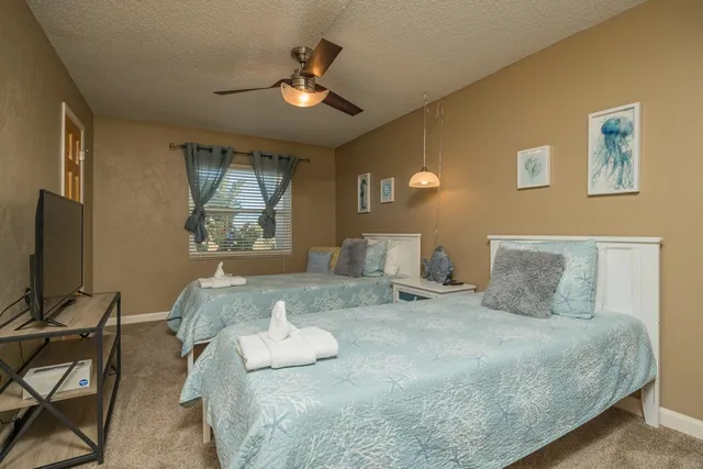 a bedroom with a bed and a chandelier