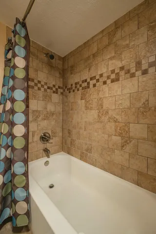 a bathroom with a bathtub and shower