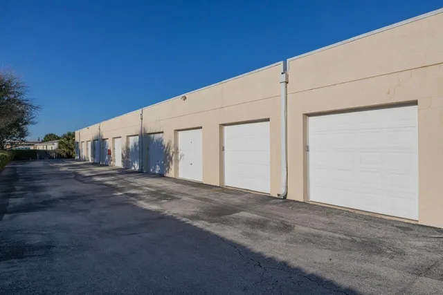 a view of empty room with garage and wooden fence