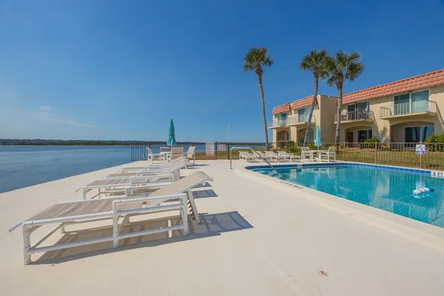 a view of a swimming pool with a lounge chair