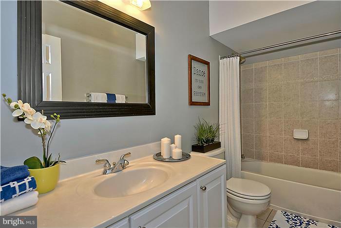 11349 King George Drive, Unit 10 Silver Spring, MD 20902 - Photo 13 of 20 a bathroom with a granite countertop sink a toilet and a mirror