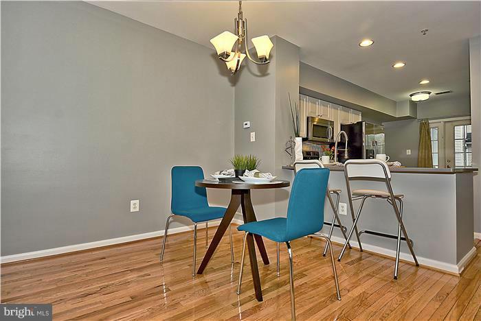 11349 King George Drive, Unit 10 Silver Spring, MD 20902 - Photo 7 of 20 a view of a dining room with furniture a chandelier and wooden floor