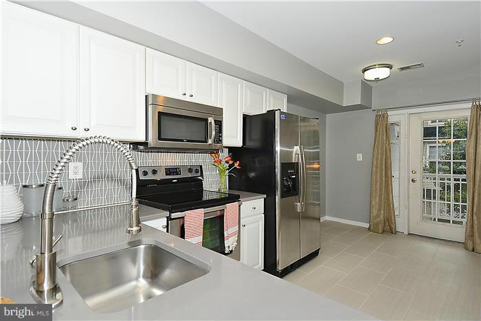 11349 King George Drive, Unit 10 Silver Spring, MD 20902 - Photo 9 of 20 a kitchen with granite countertop a refrigerator and a sink