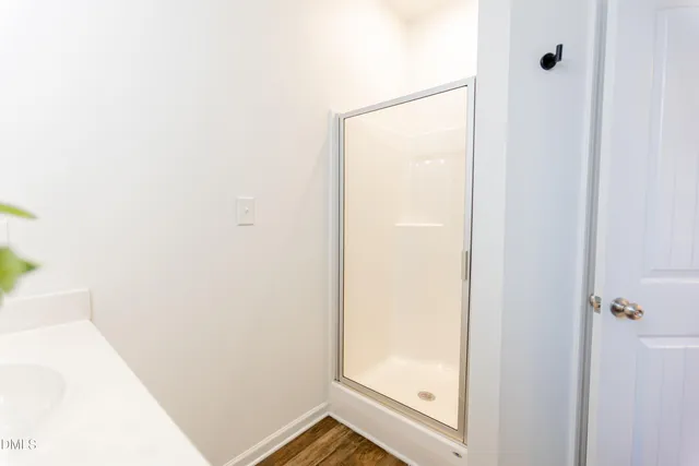 a bathroom with a glass shower door