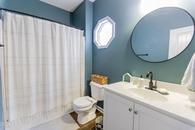 a white toilet sitting next to a shower curtain