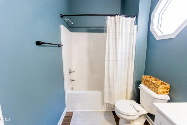 a bedroom with a bed and a potted plant