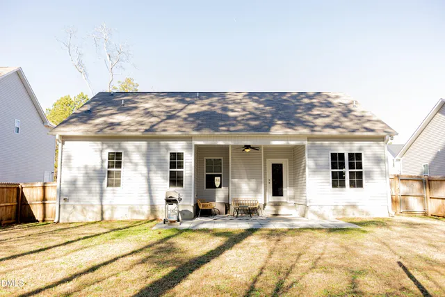 a view of a house with a backyard