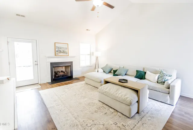 a living room with furniture and a fireplace