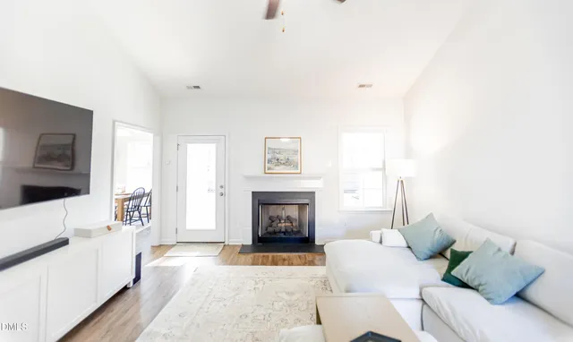 a living room with furniture and a fireplace
