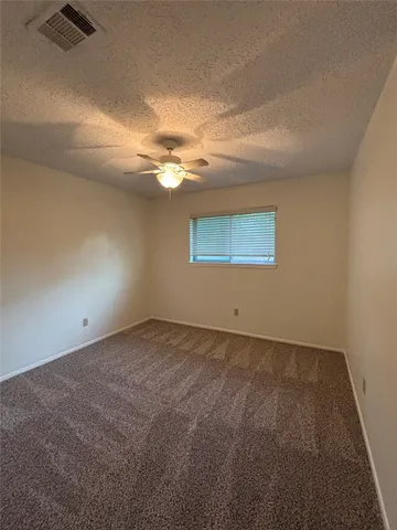 an empty room with a empty space and a ceiling fan
