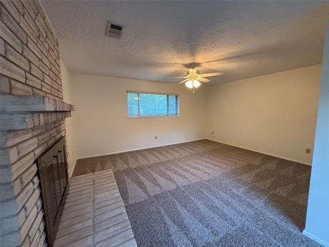 a view of a livingroom with wooden floor and a ceiling fan