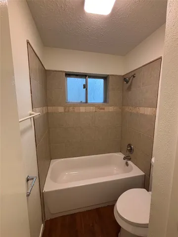 a bathroom with a bathtub toilet and sink