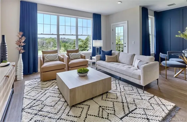 a living room with furniture and kitchen view