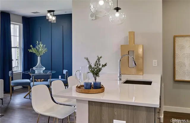 a kitchen with kitchen island a large counter top space appliances and cabinets