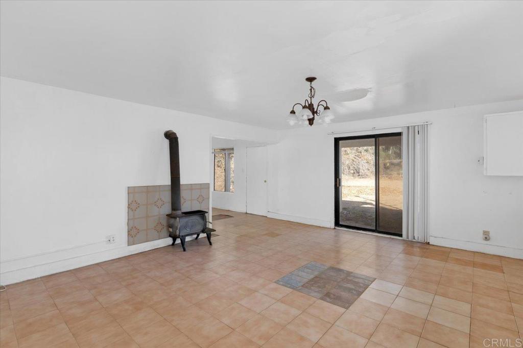 34174 Hampton Road Pauma Valley, CA 92061 - Photo 4 of 20 a view of a room with gym equipment and a chandelier