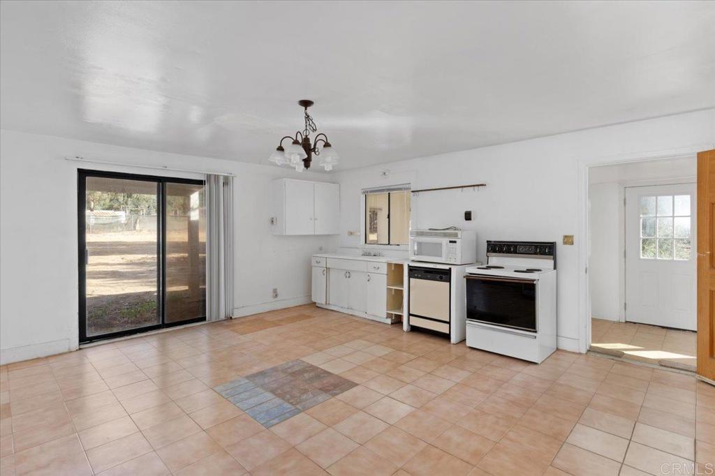 34174 Hampton Road Pauma Valley, CA 92061 - Photo 5 of 20 a view of a kitchen with white cabinets and white appliances