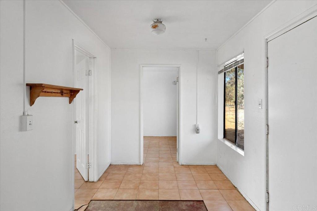 34174 Hampton Road Pauma Valley, CA 92061 - Photo 8 of 20 a view of a hallway with wooden floor and staircase