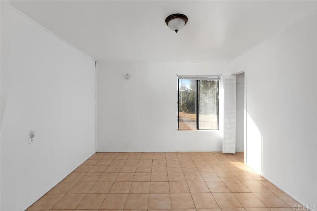 34174 Hampton Road Pauma Valley, CA 92061 - Photo 9 of 20 a view of an empty room and window
