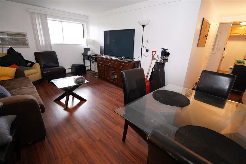 140 Kenrick Street, Unit 8 Boston, MA 02135 - Photo 2 of 16 a living room with furniture and a flat screen tv