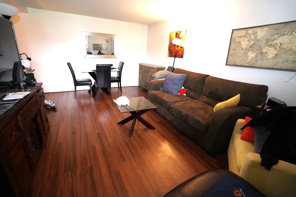140 Kenrick Street, Unit 8 Boston, MA 02135 - Photo 3 of 16 a living room with furniture and a wooden floor
