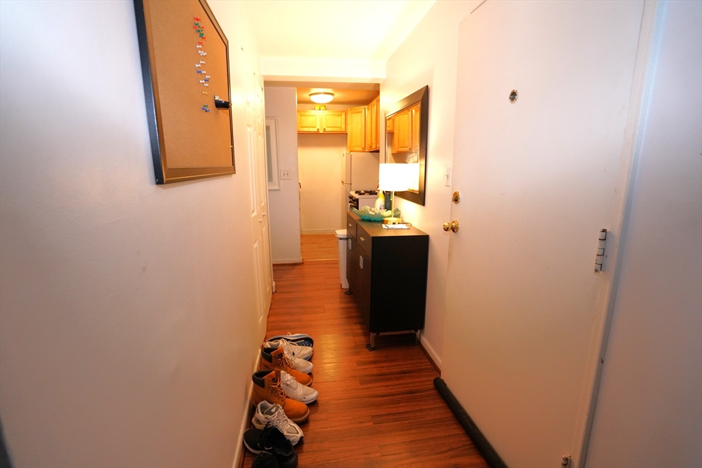 140 Kenrick Street, Unit 8 Boston, MA 02135 - Photo 4 of 16 a view of a hallway with wooden floor and entryway