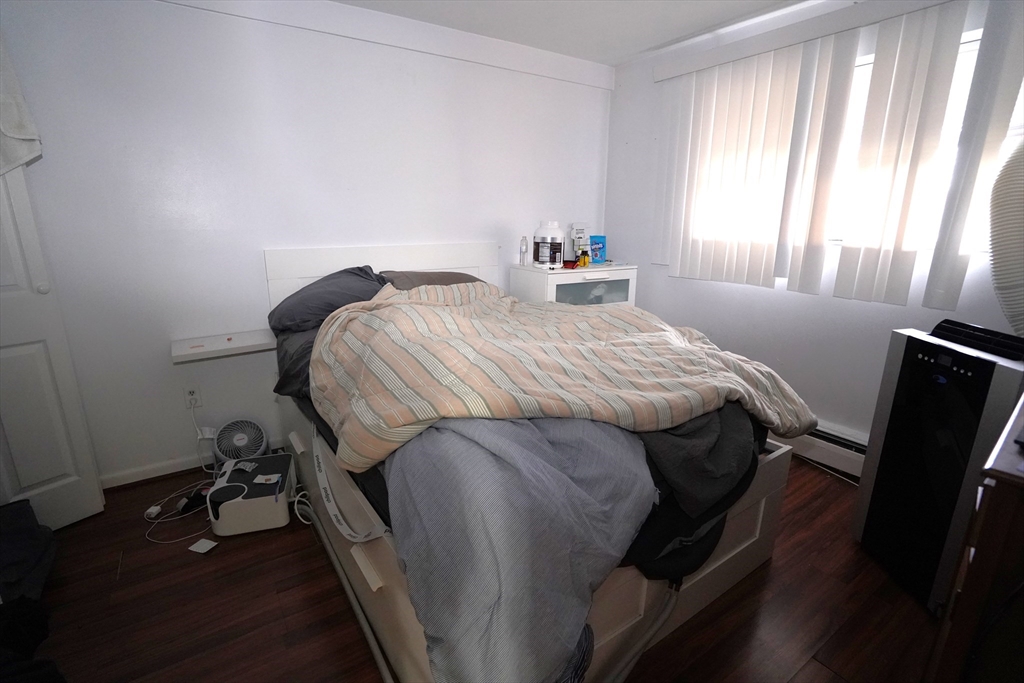 140 Kenrick Street, Unit 8 Boston, MA 02135 - Photo 7 of 16 a bedroom with a bed and a window
